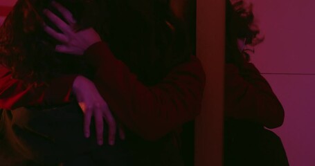 passion, love - young couple kissing in the dark in front of the mirror