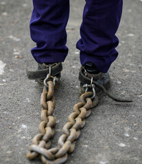 Shallow depth of field (selective focus) details of a policeman who tied a rusty metal chain to his...