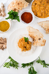 Chicken with rice in curry sauce-a traditional Indian dish on a white background