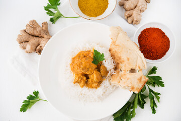 Chicken with rice in curry sauce-a traditional Indian dish on a white background