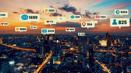 Social media icons fly over city downtown showing people engagement connection through social network application platform . Concept for online community and social media marketing strategy .