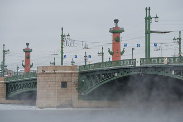 Fototapeta na wymiar Palace Bridge and Rostral Columns on a frosty February day. Saint-Petersburg, Russia