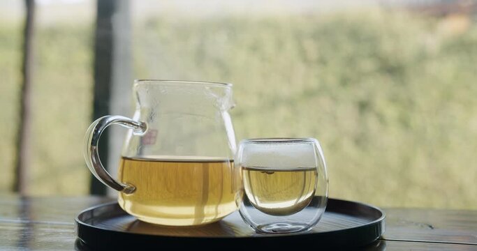 steaming hot tea in transparent teapot and a glass with smoke, Healthy Chinese tea rich in antioxidants