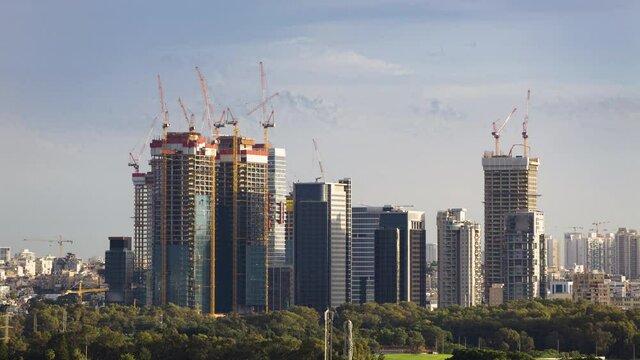 Skyscraper Construction Sites In 
Ramat Gan And Tel Aviv , Day To Night Time lapse - Tilt Up
