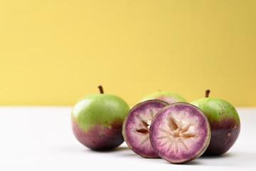Ripe star apple fruit on white and yellow background, Tropical fruit