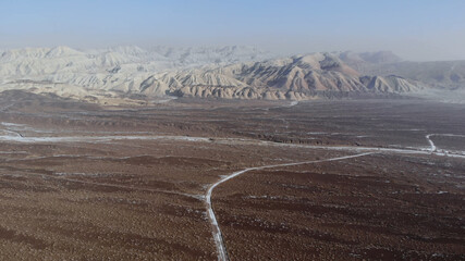 arid desert mountains.
Aerial view from drones to dry mountains. Vast open desert landscape. Clay mountains
Earth destroyed by erosion and global warming