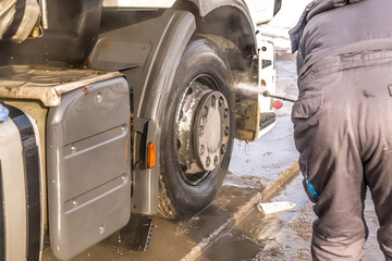Truck washing. Close-up of dirty truck wheels.