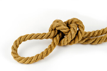 Hemp rope with tied knot in close-up on white background.