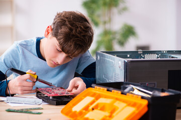 Boy reparing computers at workshop