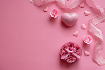 Natural spa set with bath salt and soap rosebuds on a pink background. Valentine's Day, birthday, mother's day, 8 March. Top view, flat lay.