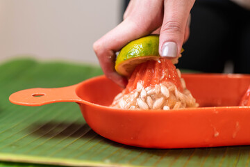 woman's hands squeezing lime juice