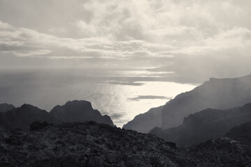 clouds over the mountains and the sea