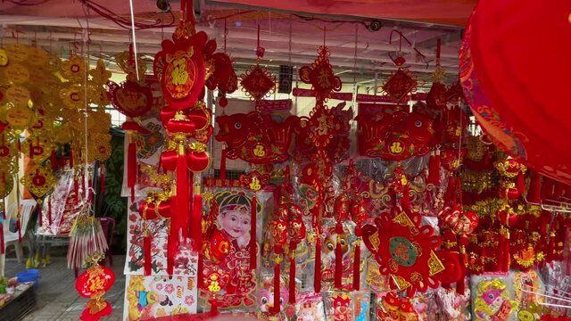 Slowmotion shot of colorful red and golden Chinese lanterns sold on an Asian street market prior to the Tet holiday or Lunar new year in Asia. TET concept. Travel to Asia. Letterings on lanterns and