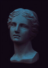 Gypsum copy of ancient statue Venus head on black background. Plaster sculpture woman face. Multi color toned.