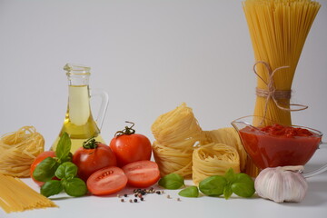 Food ingredients for Italian pasta, tomatoes basil garlic olive oil and parmesan cheese