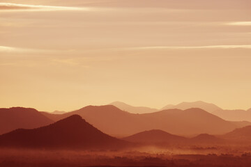 Landscape Arrange Mountains hill with mist fog  in the morning - nature scenery from  Phuthok Chaing Khan Loei Thailand , dark red nature image background and Backdrop