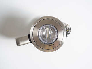 electric metal kettle in silver color on a bright white background. Top view, flat lay