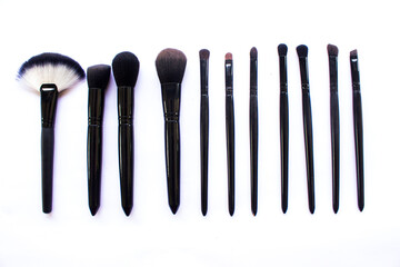 makeup brushes set isolated on white background. Top view, flat lay