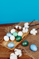 Easter traditions holiday colorful eggs on a wooden table blue background in the background