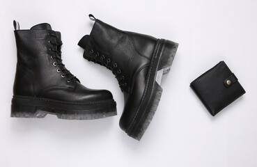 Black Leather boots and wallet on white background. Top view. Flat lay