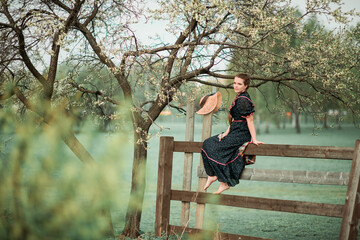 a girl in a blooming garden