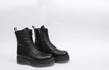 Black Fashionable high-soled leather boots on white background