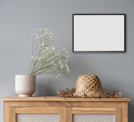Blank picture frame mockup on gray wall. Scandinavian living room design. View of modern style...