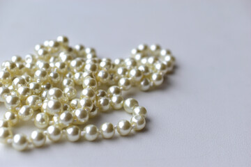 White pearl necklace beads on white background