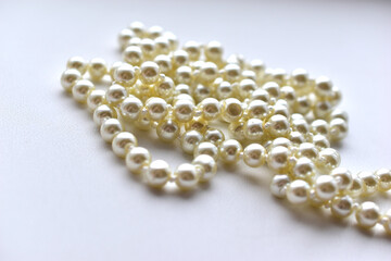 White pearl necklace beads on white background