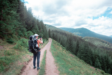 Fototapeta na wymiar young hiker man in mountains. summer trekking path