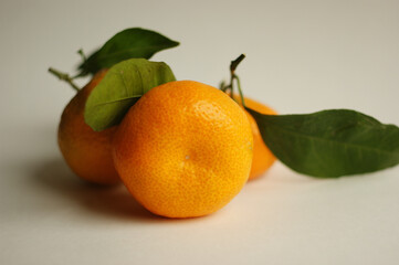 ripe and juicy tangerine (mandarin). fresh tangerine with leaf on white, closeup