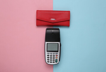 Payment terminal with red wallet on pink blue background. Top view