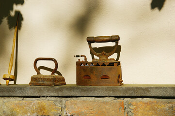 vintage iron. retro coal heated iron on a stone shelf