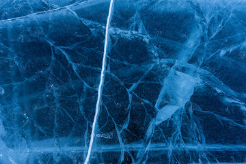 shot of frozen waters full of cracks of baikal lake ice. Texture.