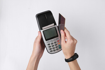 POS terminal and hands with payment card on white background