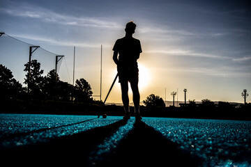 Field Hockey Silhouette on Blue Astroturf