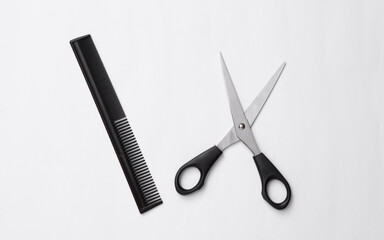 Scissors and hairbrush on a white background. Set for haircuts, hair care, barbershop