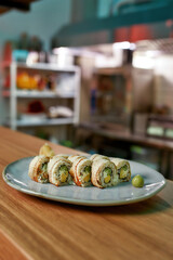 Closeup of a plate with sushi rolls ready to be served in a restaurant