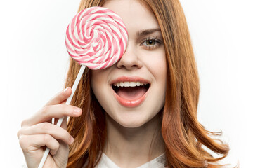 attractive woman with lollipop in hands enjoying joy sweets