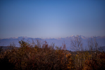 autumn landscape overlooking the horizon where the ridges of the high mountains can be seen. high hills full of dense forests