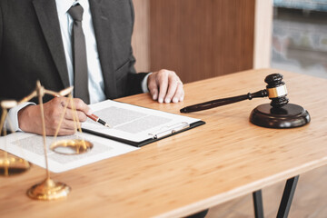 Legal counsel presents to the client a signed contract with gavel and legal law. justice and lawyer concept.