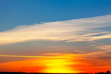 Vibrant sky during the twilight . The silhouette of the city in the evening