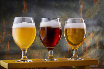 Beer in glassware on stone background