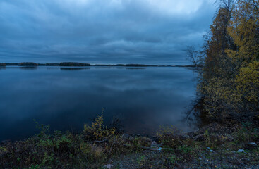Man made lake basin with boreal forest in autumn