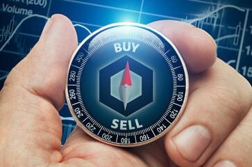 Male hand holding compass with chainlink altcoin in front of stock market chart data. Compass needle showing buy word. Cryptocurrency trading concept.