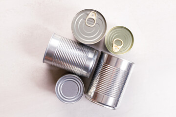 Various canned vegetables on kitchen table background.