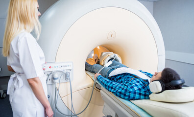Radiologist prepares the patient for an MRI knee examination