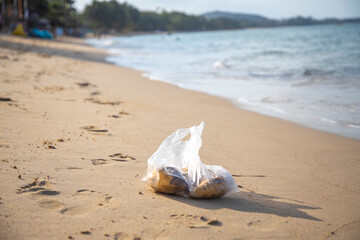 Fototapeta na wymiar plastic bag lying on a sandy tropical beach. environmental pollution