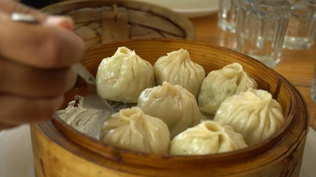 serving steamed dumplings with fork