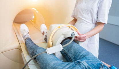 Radiologist prepares the patient for an MRI knee examination